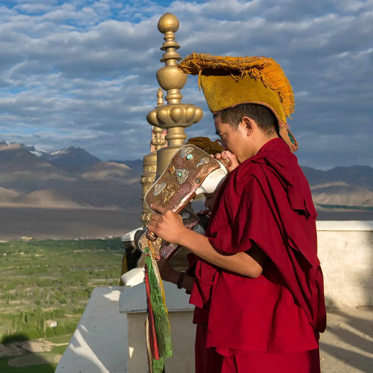 Thiksey gompa monk blowing conch Ladakh photo tour